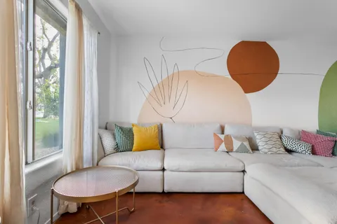 a view of a dining room with furniture and window