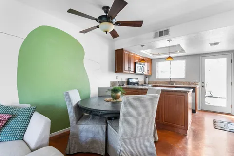 a bedroom with a bed a table and chair