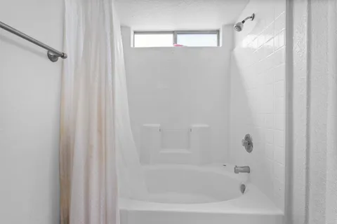 a bedroom with a bed and a lamp