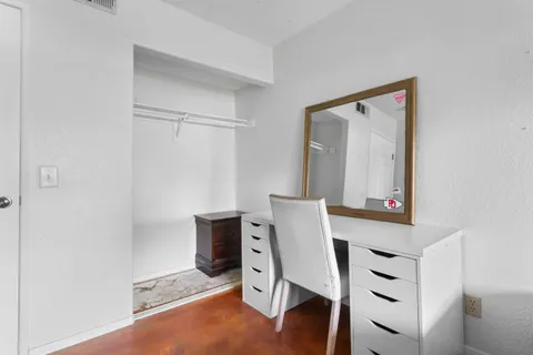 a bedroom with a bed and painting on the wall