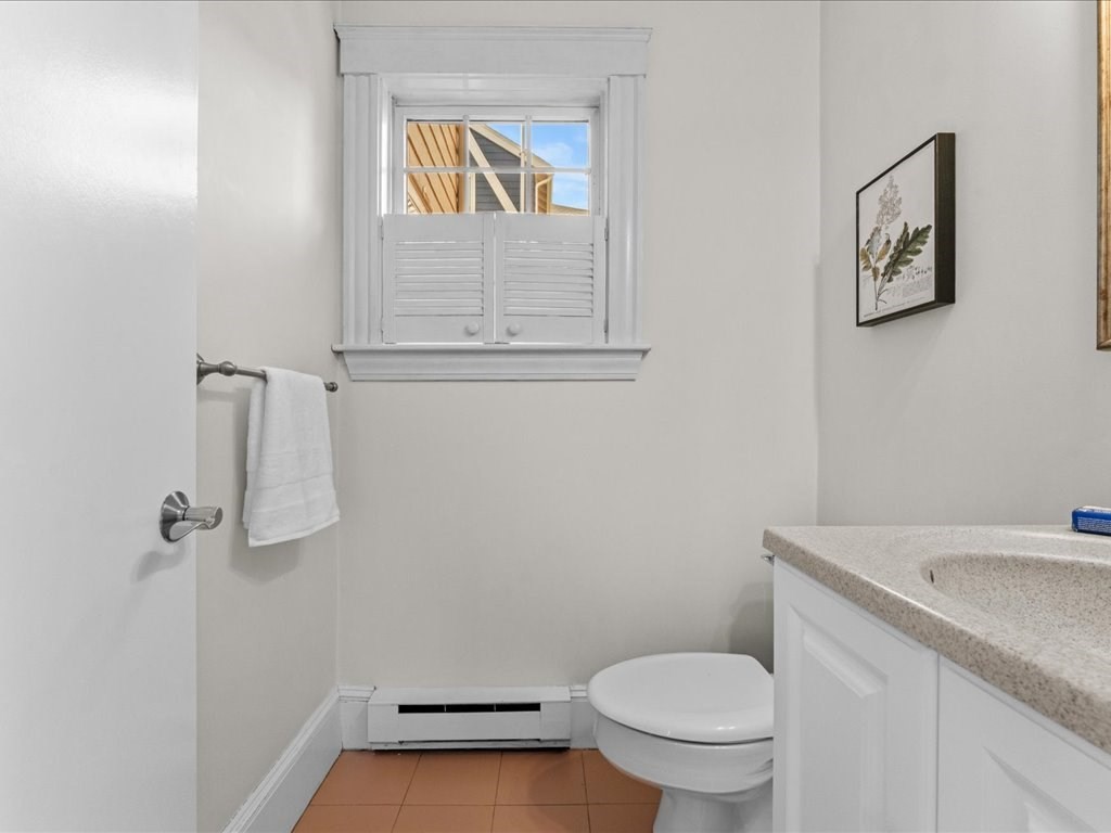 55 Coolidge Road Arlington, MA 02476 - Photo 14 of 42 a bathroom with a granite countertop toilet and a sink