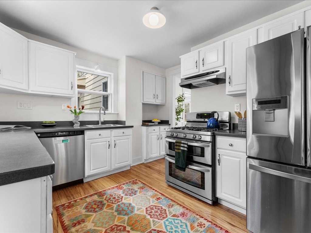 55 Coolidge Road Arlington, MA 02476 - Photo 16 of 42 a kitchen with stainless steel appliances granite countertop a refrigerator sink and stove