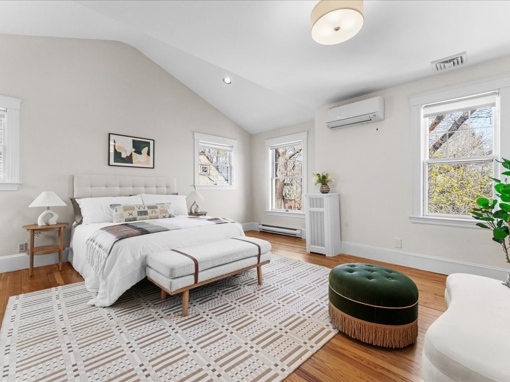 55 Coolidge Road Arlington, MA 02476 - Photo 20 of 42 a bedroom with a bed and a wooden floor