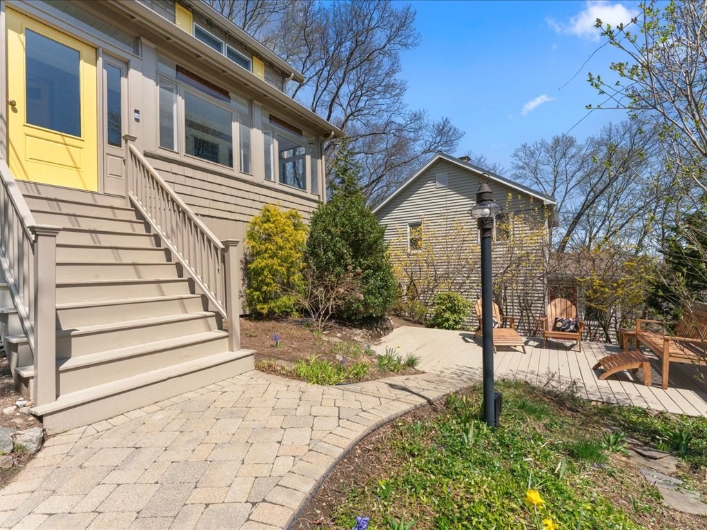 55 Coolidge Road Arlington, MA 02476 - Photo 2 of 42 a front view of a house with a yard and garage