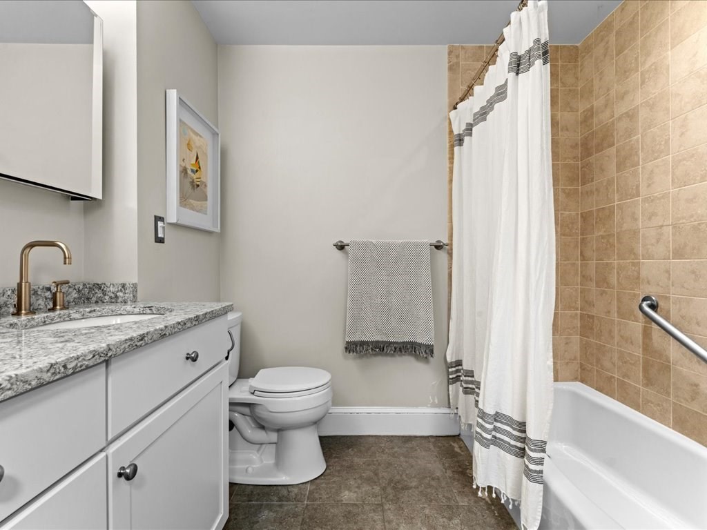 55 Coolidge Road Arlington, MA 02476 - Photo 26 of 42 a bathroom with a granite countertop sink toilet and shower