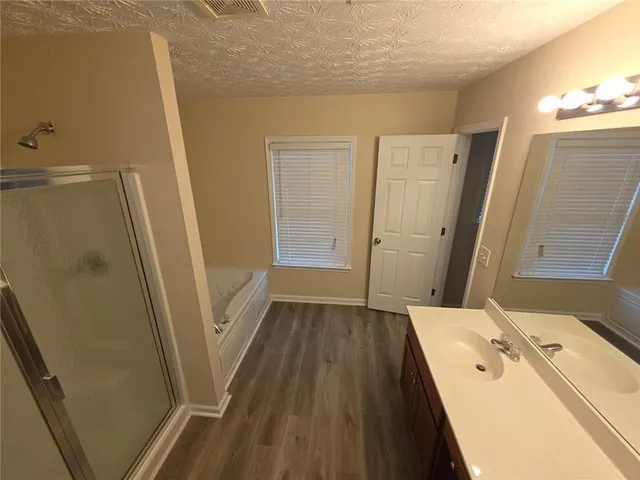 a bathroom with a sink a toilet and a shower