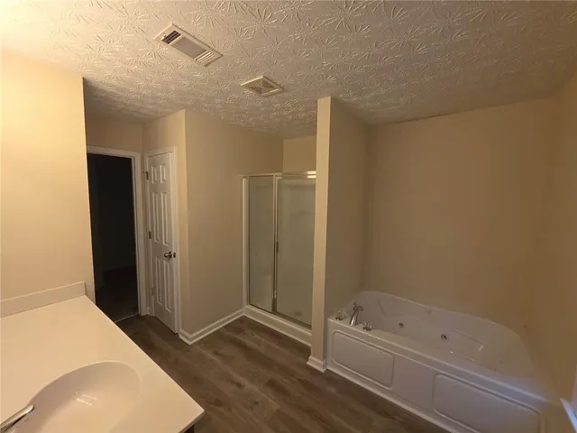 a bathroom with a tub and shower