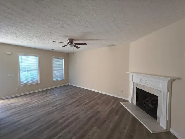 a view of a livingroom with a fireplace and window