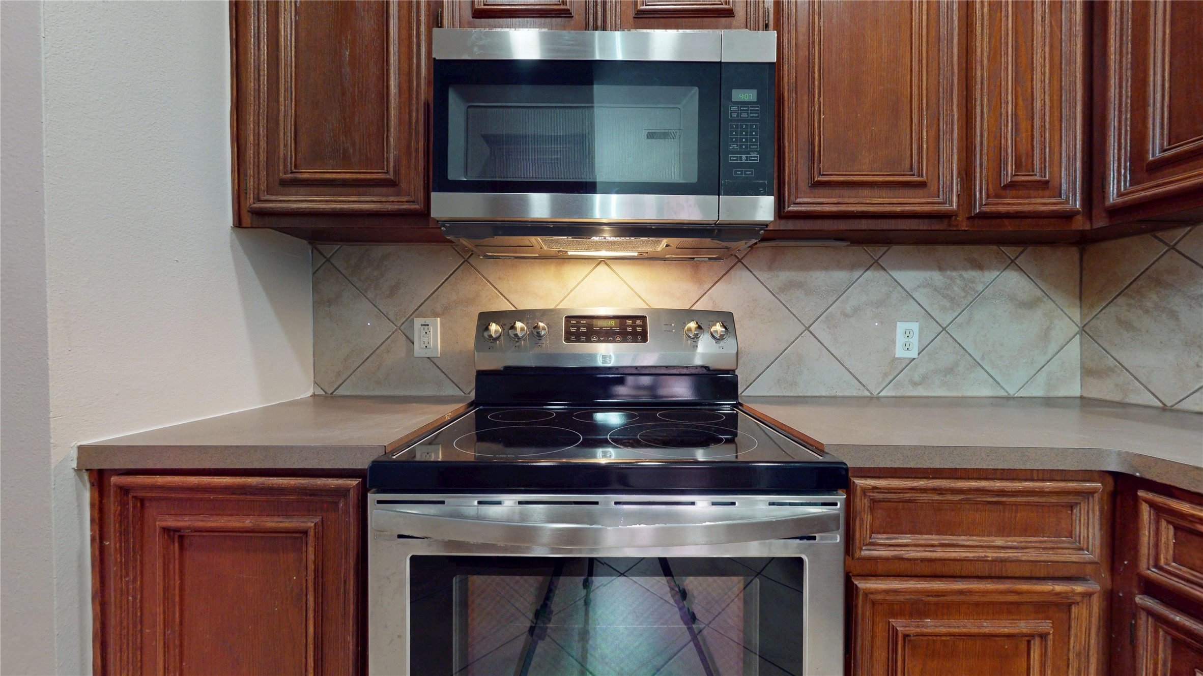 16611 Cheshire Grove Lane Houston, TX 77090 - Photo 13 of 40 a stove top oven sitting inside of a kitchen