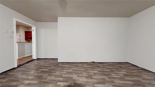 a hallway with stainless steel appliances a sink and a refrigerator
