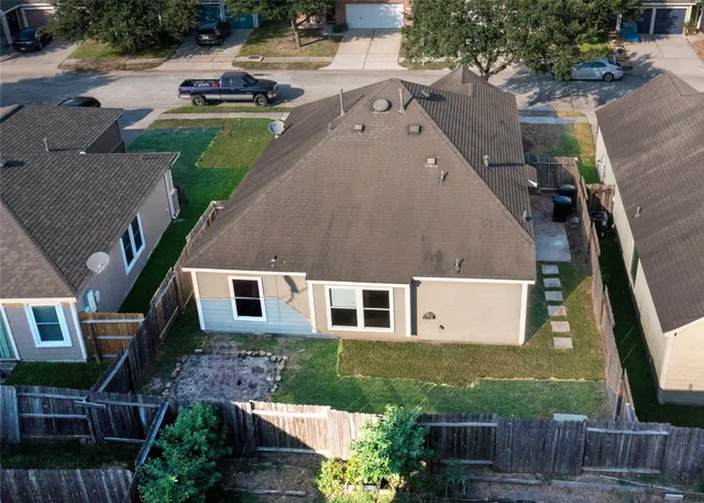 an aerial view of a house with garden space and street view