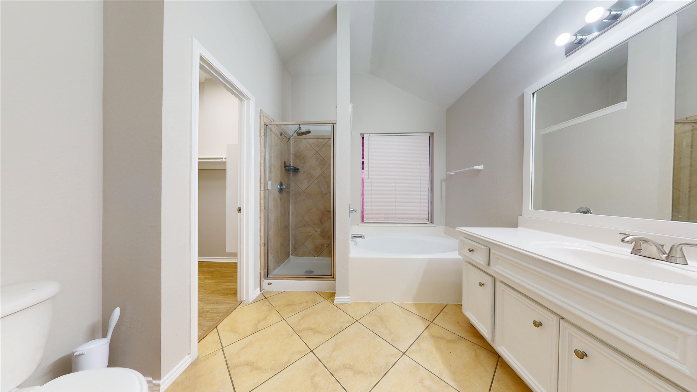 16611 Cheshire Grove Lane Houston, TX 77090 - Photo 22 of 40 a spacious bathroom with a tub mirror and toilet