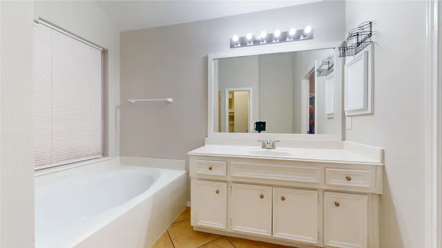 a bathroom with a sink vanity and a mirror