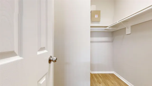 a view of walk in closet with empty racks