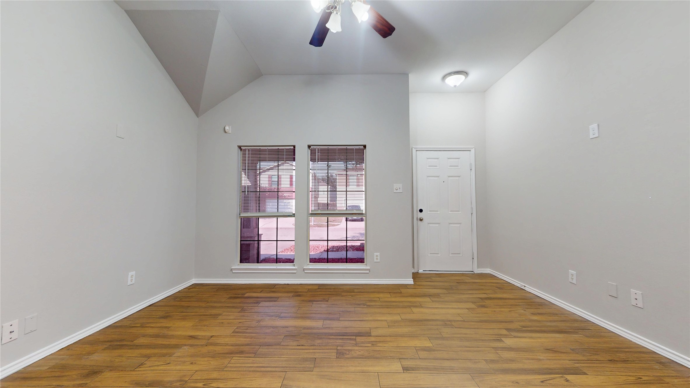 16611 Cheshire Grove Lane Houston, TX 77090 - Photo 6 of 40 an empty room with chandelier fan and windows
