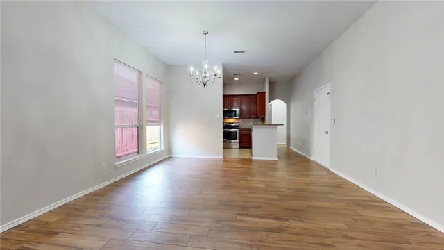 a view of a kitchen with a dishwasher cabinets and wooden floor