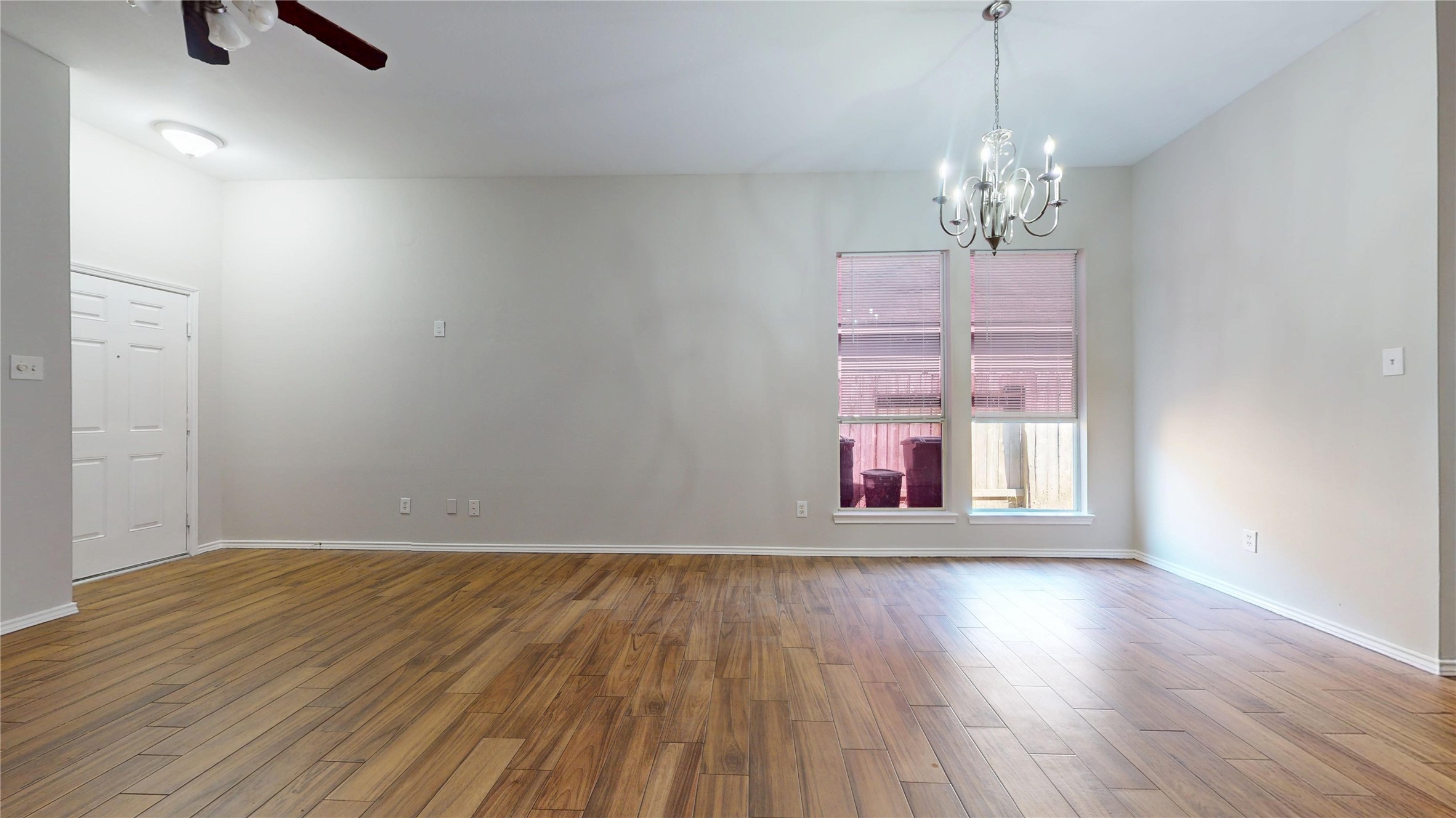 16611 Cheshire Grove Lane Houston, TX 77090 - Photo 9 of 40 a view of an empty room with wooden floor and a window