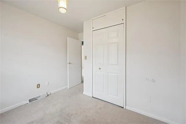 an empty room with closet area
