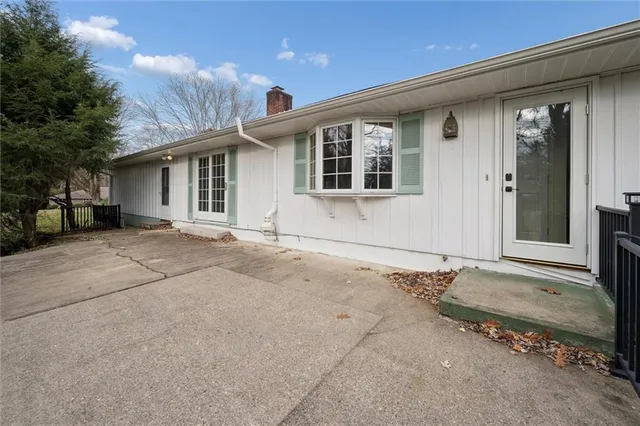 a view of a house with a yard and sitting area