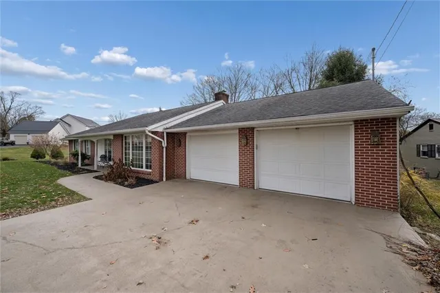 a view of a house with backyard and sitting area