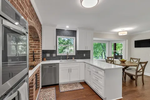 a kitchen with a sink stove and cabinets