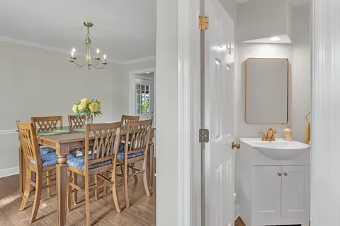 a view of a dining room with furniture and chandelier