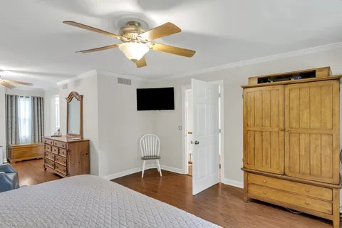 a bedroom with a bed and a chandelier