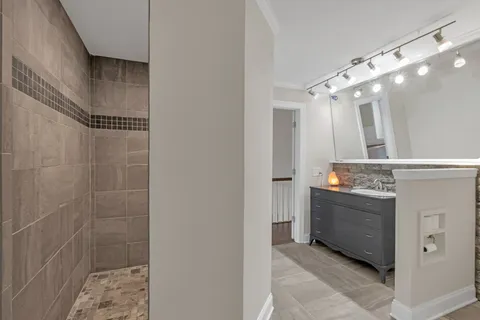 a bathroom with a mirror and a shower