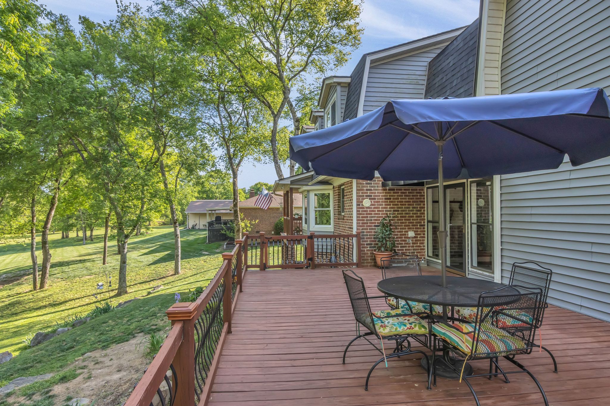 2248 Racquet Club Drive Murfreesboro, TN 37128 - Photo 34 of 41 a view of a deck with table and chairs under an umbrella