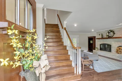 a view of entryway and hall with wooden floor