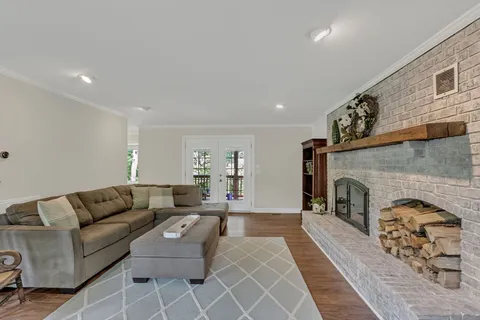 a living room with furniture a fireplace with wooden floor