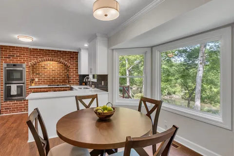 a view of a dining room with furniture and window
