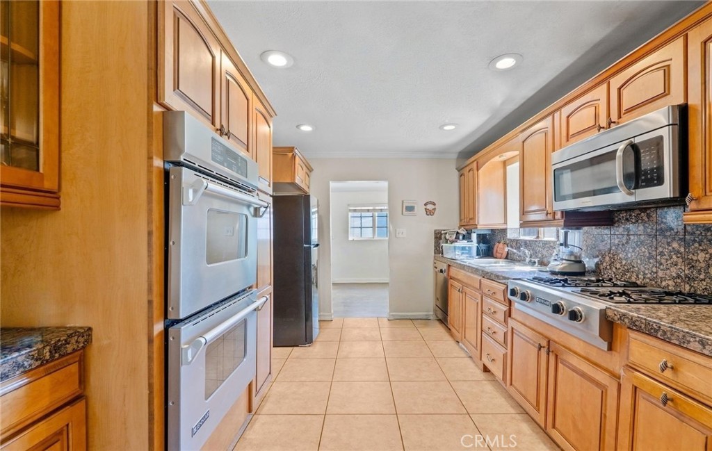 5729 Juarez Avenue Whittier, CA 90606 - Photo 12 of 42 a kitchen with stainless steel appliances granite countertop a refrigerator a stove and a sink