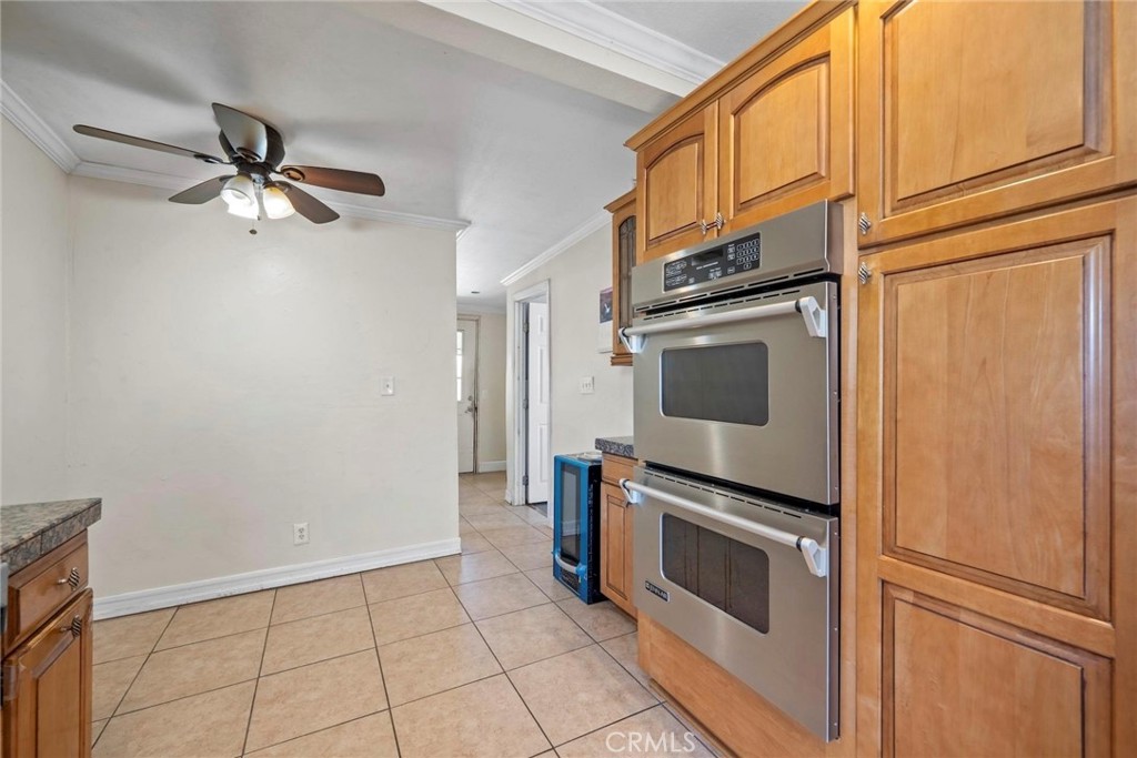 5729 Juarez Avenue Whittier, CA 90606 - Photo 14 of 42 a kitchen with granite countertop a stove top oven microwave and a refrigerator