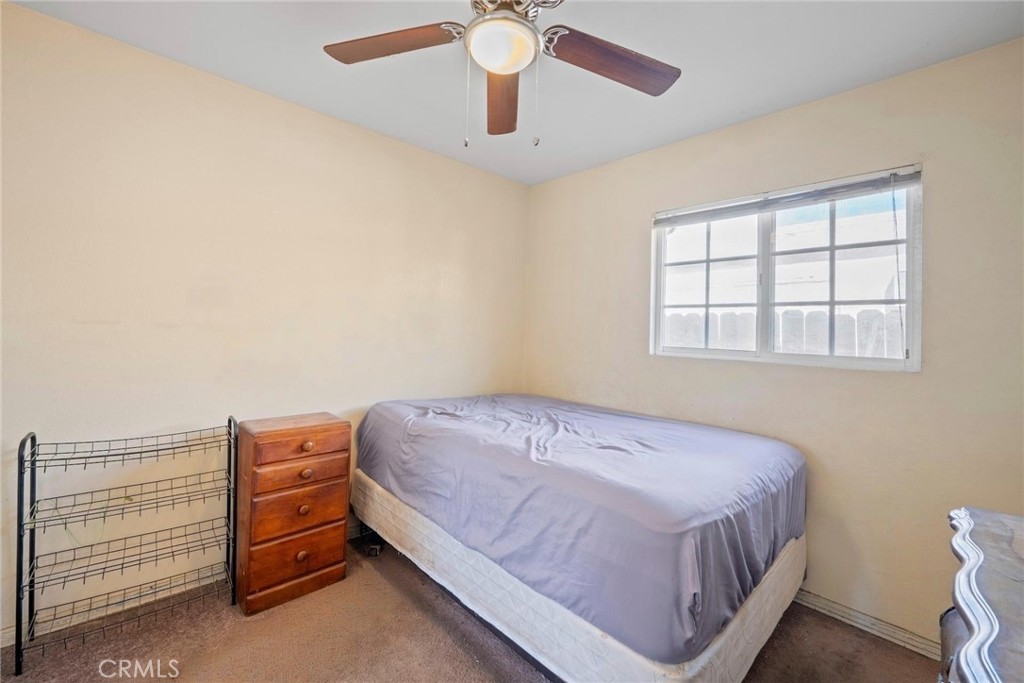 5729 Juarez Avenue Whittier, CA 90606 - Photo 16 of 42 a bedroom with a bed and a chandelier