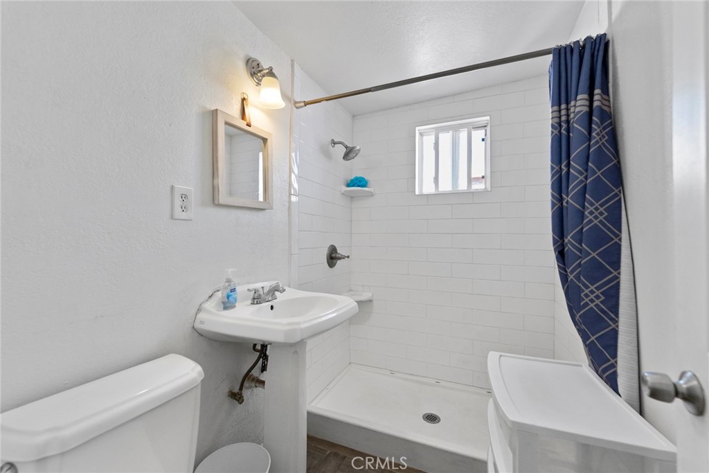 5729 Juarez Avenue Whittier, CA 90606 - Photo 22 of 42 a bathroom with a sink a toilet a mirror and shower