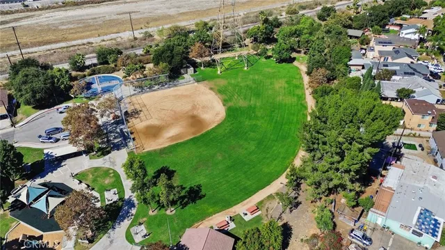 an aerial view of a house with a yard and garden