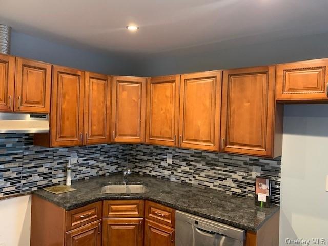 a view of a kitchen with granite countertop cabinets
