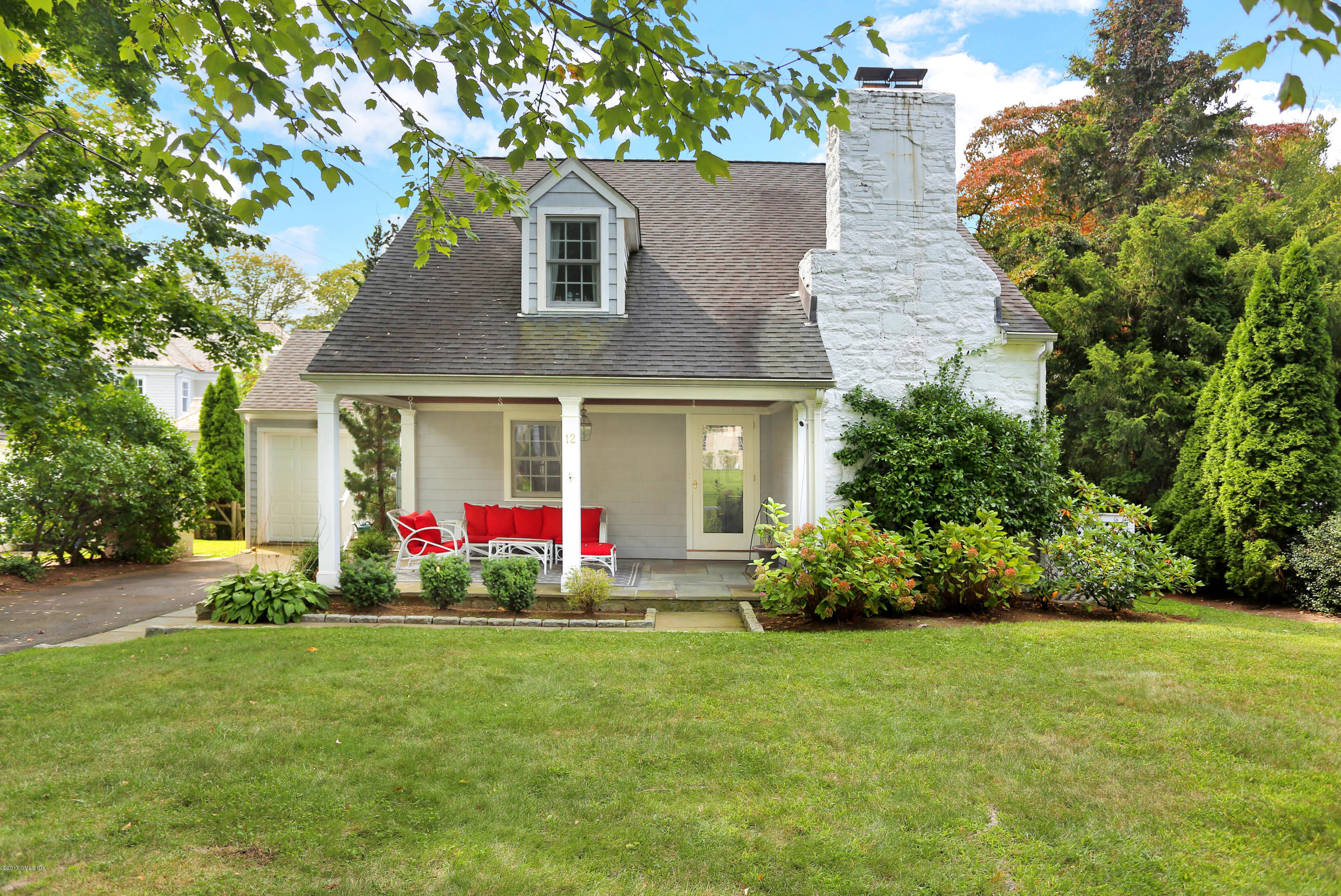 12 Oval Avenue Riverside, CT 06878 - Photo 1 of 1 a front view of house with yard and outdoor seating