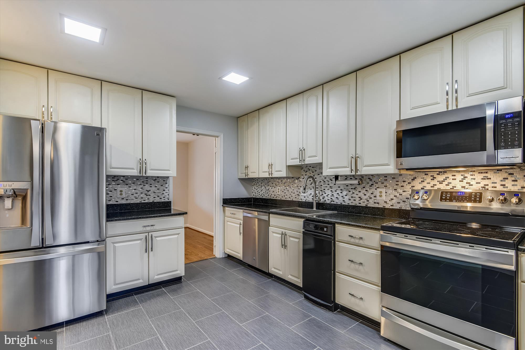 11328 Dockside Circle Reston, VA 20191 - Photo 6 of 44 Granite, stainless, ceramic tile, backsplash