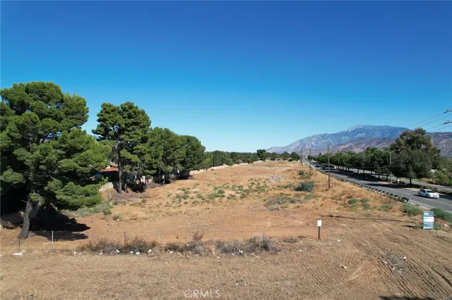 a view of a road with a snow on the background