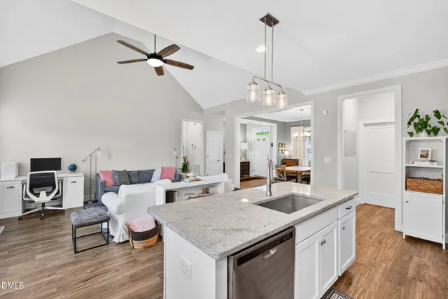 a kitchen with a stove a counter space and wooden floor