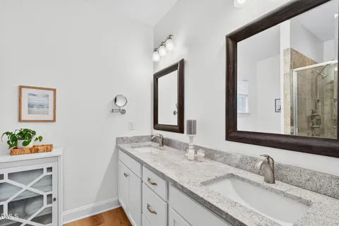 a bathroom with 2 sink and a mirror