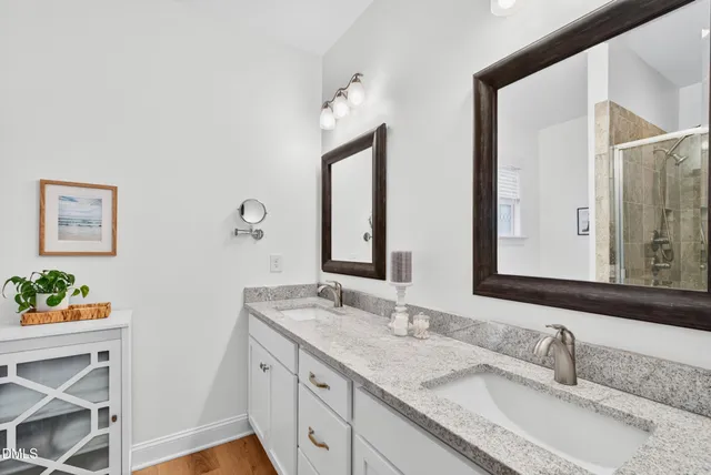 a bathroom with 2 sink and a mirror