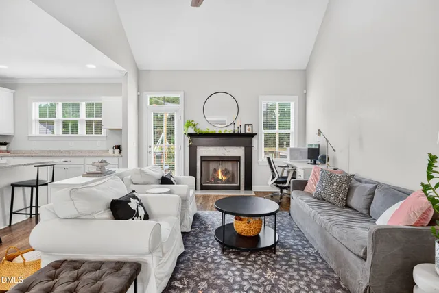 a living room with furniture a window and a fireplace