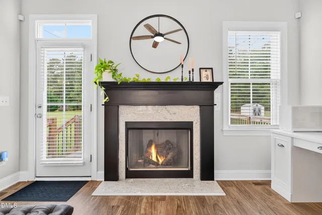 a living room with a fireplace and a window