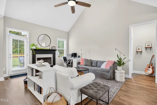 a living room with furniture a fireplace and wooden floor