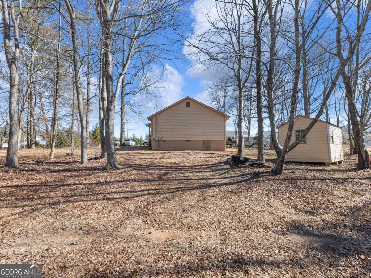 5539 McEver Road Flowery Branch, GA 30542 - Photo 13 of 41 a view of a house with a yard covered in snow