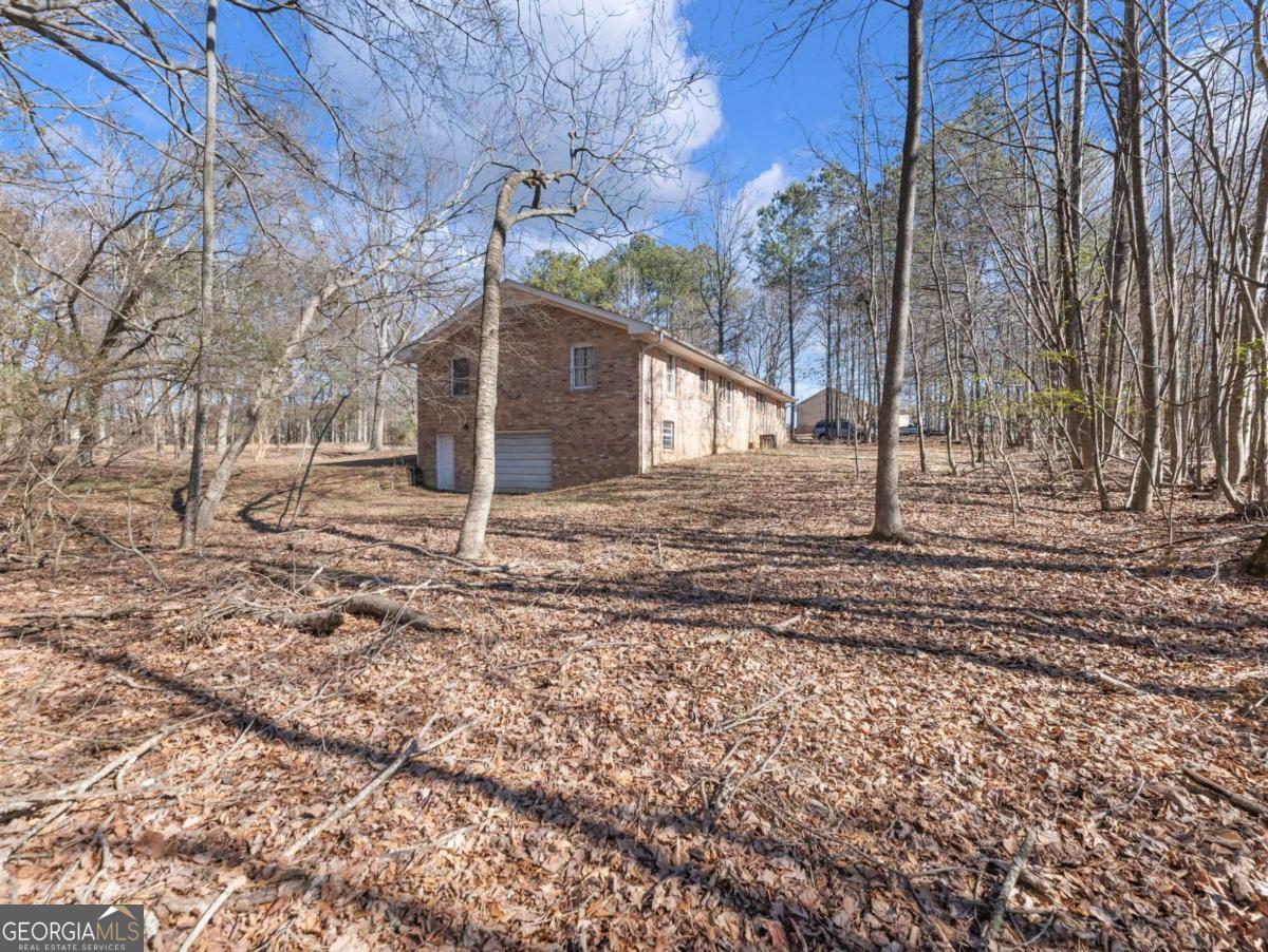 5539 McEver Road Flowery Branch, GA 30542 - Photo 26 of 41 a backyard of a house with lots of green space