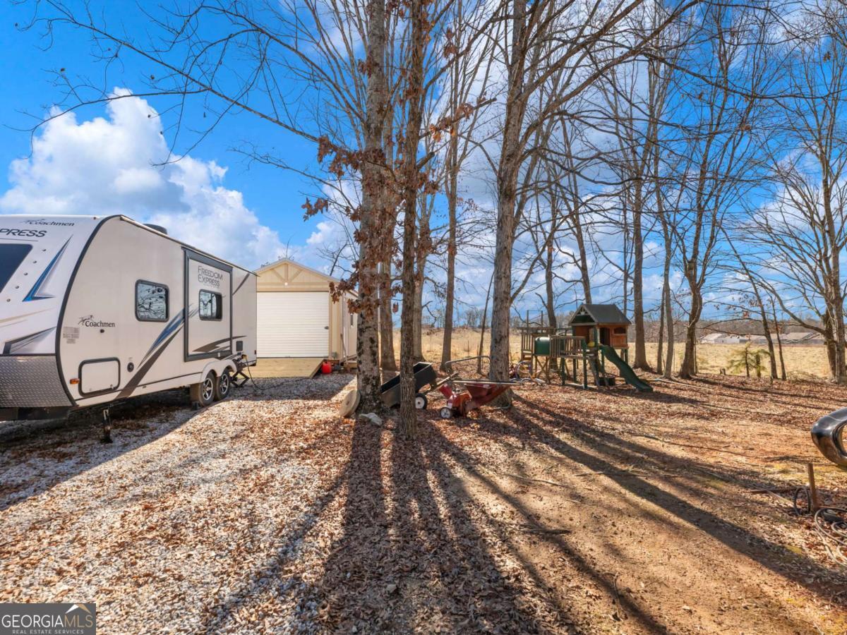 5539 McEver Road Flowery Branch, GA 30542 - Photo 3 of 41 a view of a backyard of the house